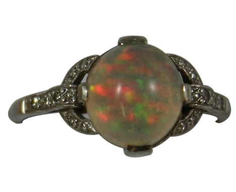 An  Art Deco 18ct white gold, opal and diamond dress ring, claw set with a cabochon stone, single cut diamond set shoulders, 