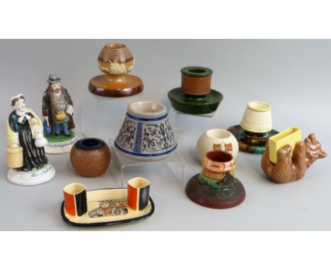 A collection of eleven vesta holders and match strikers, comprising Doulton salt glazed stoneware with toping scenes, Doulton