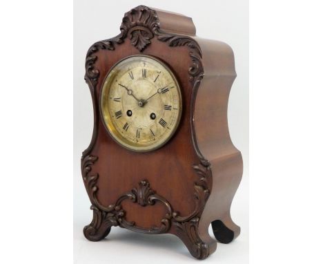 An early 20th century French mahogany mantle clock, retailed by A.T. Smith, the shaped case with applied floral border, silve