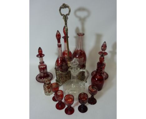 Late Victorian silver-plated three bottle holder containing three similar ruby overlaid glass decanters, near pair of similar