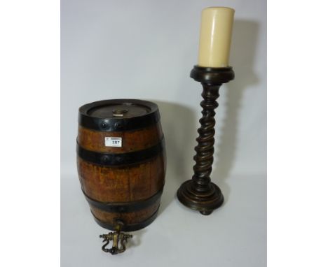 Late 19th/early 20th century metal bound oak barrel with tap and a turned wood candle stick 