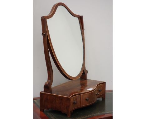 Early 19th century figured mahogany shield shaped toilet mirror, serpentine front, fitted with three mahogany lined drawers, 