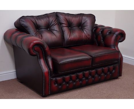 Two seat Chesterfield sofa (W150cm), and matching armchair (W100cm), upholstered in deeply buttoned red leather