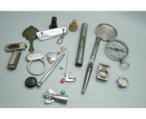 A collection of items including a compass, small tools, mini harmonica, etc.