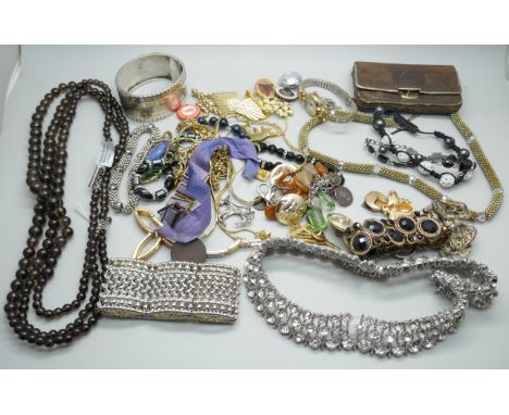 A collection of jewellery including a white metal cuff bangle, a silver mounted smoky quartz necklace and a silver mounted pu