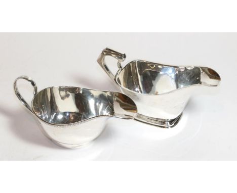 Two George V silver sauceboats, the first by Thomas Fattorini, Birmingham, 1934, oblong and on conforming foot, 17cm wide, th