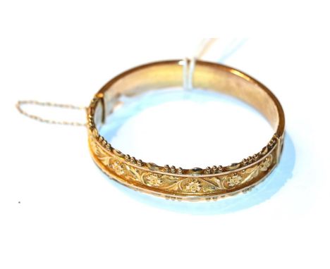 A 9 carat gold hinged bangle .  Gross weight 12.3 grams. 