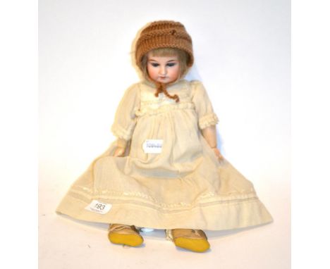 A late 19th early 20th century bisque head doll marked G K with blue glass eyes.  