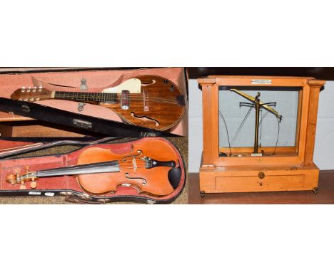 A full sized violin, bears label to interior and two bows, cased and an early 20th century rosewood mandolin, cased and a set
