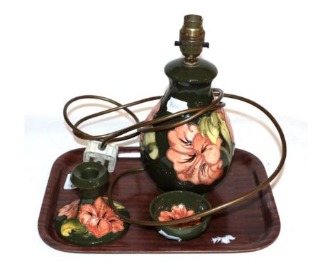 A 1970's modern Moorcroft lamp coral hibiscus pattern, 26cm high, candle holder and small bowl (3).  Minor wear throughout, o