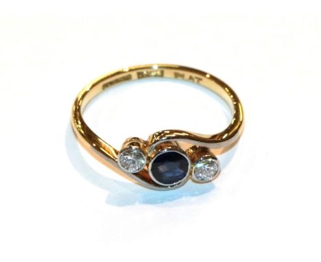 A sapphire and diamond twist ring, stamped '18CT' and 'PLAT', finger size L1/2 .  The ring is in good condition with slight s