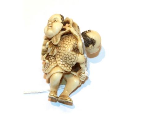 Japanese ivory netsuke, fisherman with fish and mask, 4.5cm high .  Weight 15g