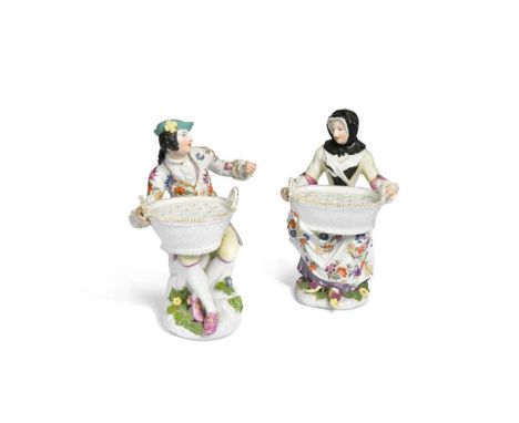 A pair of Meissen bouquetiere figures, circa 1765, modelled by J.J. Kändler, holding oval two-handled baskets, the tops pierc