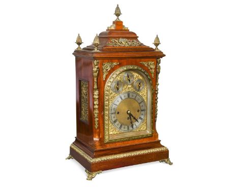 An imposing Edwardian mahogany and gilt metal mounted table clock, with arched silvered dial, having three subsidiaries above
