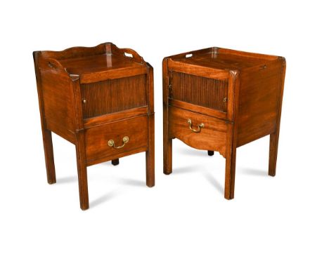 A near pair of George III mahogany night cupboards, the tray tops above a tambour front cupboard door over a sliding commode 