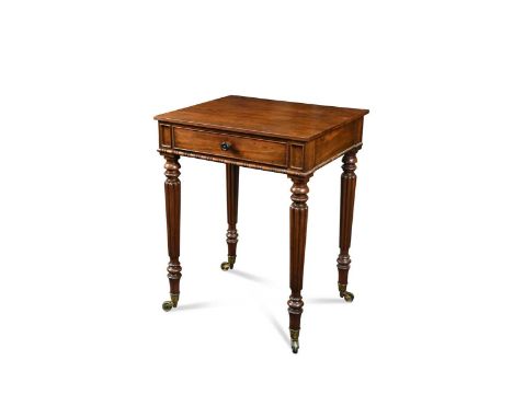 the rectangular top over a single frieze drawer raised on turned and reeded legs with brass castors75 x 57 x 47 cmProvenance: