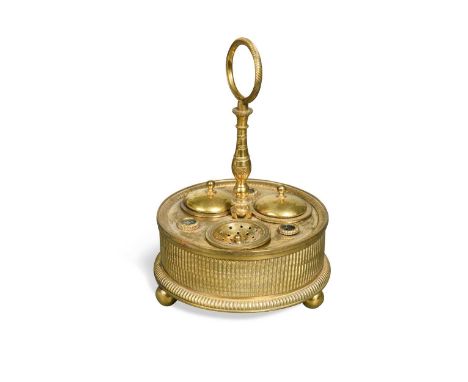 A French Empire ormolu ink stand, circa 1820, with engine turned decoration and loop handle raised on ball feet15.5cm high