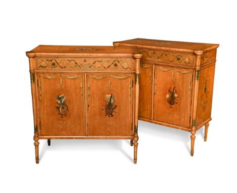 A pair of satinwood and painted two door side cabinets, 20th century, the tops decorated with a bouquet of flowers with a sin