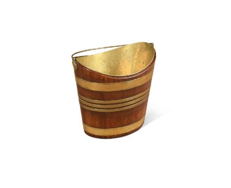 A George III mahogany and brass peat bucket, of navette form with brass swing handle37 x 37 x 27cmProvenance:Crepping Hall, S