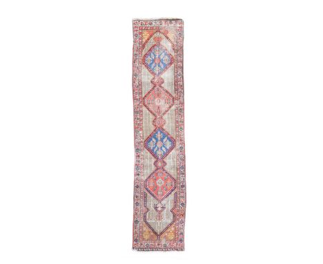 A Persian Sarab runner, circa 1900, the four alternating indigo and madder medallions within a natural coloured field of styl