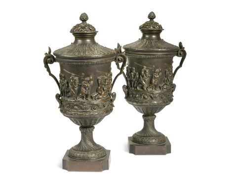 A pair of French bronze urns and covers, late 19th century, each cast in relief with a band of cavorting putti above a wrythe