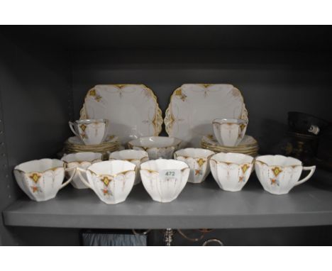 A collection of Shelley in the Diamonds pattern, having Queen Anne shaped cups with gold print, green diamond within a yellow