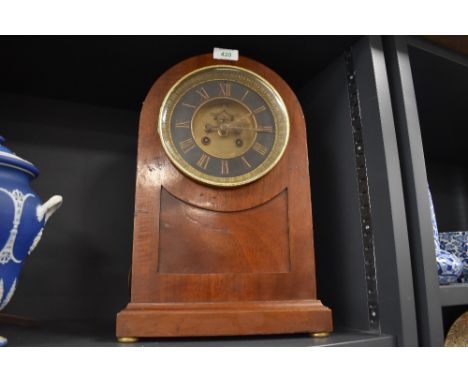An antique mahogany cased chiming mantle clock having bevelled glass hinged frontage and roman numerals to face.