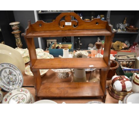 An antique mahogany wall shelf or what not