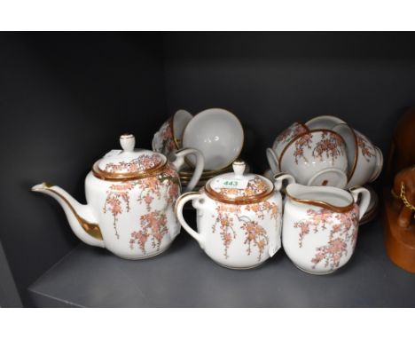 A mid century oriental part tea service having cherry blossom and gilt detailed pattern included are cups and saucers, sugar 