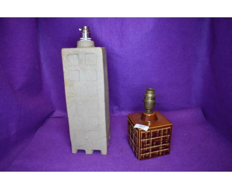 A cubic Poole pottery lamp having brown glaze with abstract design and another taller example in matte beige finish, both wit