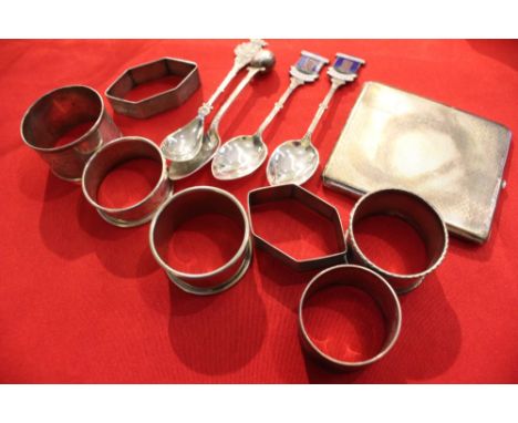 An engine turned silver cigarette case, four silver napkin rings and a "Bowls" trophy spoon, combined weight 183g, together w