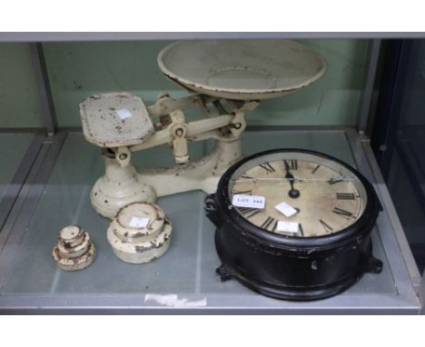 A vintage set of scales with a vintage clock