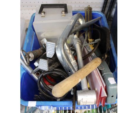 A box containing a selection of tools, bolts, springs, etc