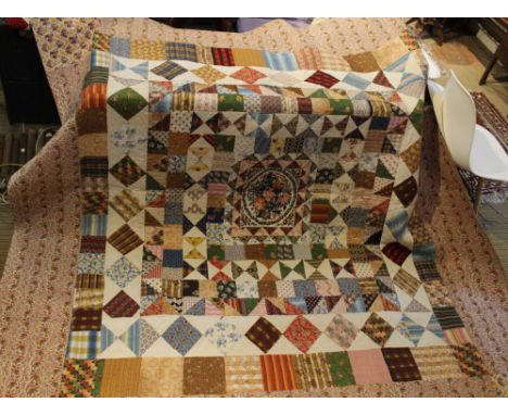 A 19th century patchwork quilt, possibly made by the Thornton sisters of Mirfield, Yorkshire, 250cm x 236cm, has discolourati