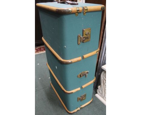 A wooden and brass bound green vintage travel trunk