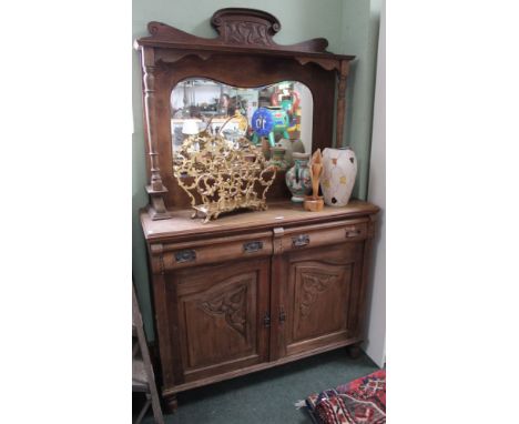 A first quarter twentieth century mirror back sideboard with carved door over two drawers and Art Nouveau style detailing