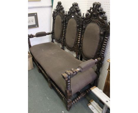 A c.1900 oak three person settle, ribbon &amp; floral decoration to the backs, bobbin turned stretchers &amp; supports, with 