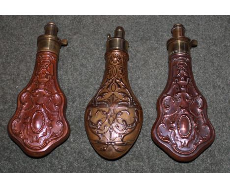 Matching pair of embossed copper and brass powder flasks by Hawksley.Copper and brass powder flask by Hawksley with climbing 