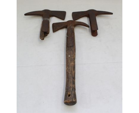 Three metal axe heads, including a small fireman axe
