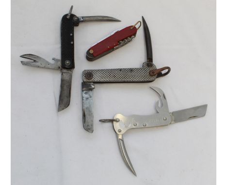 Three military Jack Knives of different types. Harrisons of Sheffield, etc. and a Swiss army type utility knife.(4)