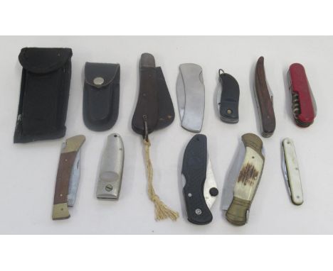 Large collection of folding pocket knives of various styles and eras. Including a vintage pruning knife, a wooden-handled fis