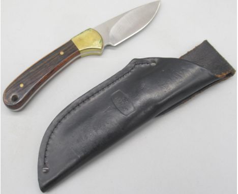 Model 113 Buck skinning knife. Full tang with two piece rosewood handle and brass bolster. Blade length 8cm, overall 18cm. In