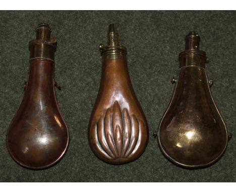 Two Copper and brass powder flask with hanging loops. Copper and brass powder flask by Battie with fluted leaf design 