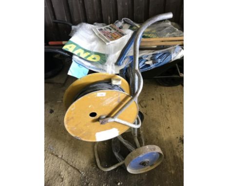 A trolley with extension reel, wheelbarrow, various tools, etc.