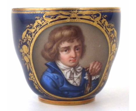 Meissen coffee cup circa 1780 painted with a portrait of a boy holding a flintlock pistol on blue ground, crossed swords and 