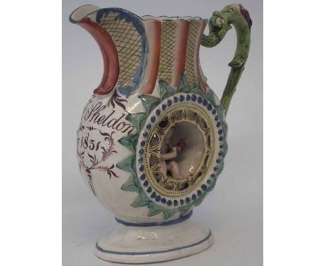 Staffordshire puzzle jug, named J. Sheldon 1831, with central hole to body enclosing a cherub, 22.5cm high     Condition repo