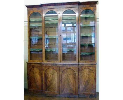 William IV mahogany breakfront bookcase of four glazed doors over four cupboard doors, width 204cm, height 262cm.
 
Condition