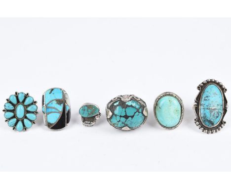 Six Navajo and Zuni turquoise set rings Southwest North America silver coloured metal, including a blossom design, a cable bo