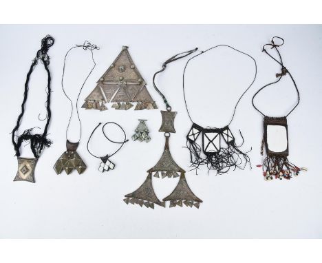 A Tuareg chest ornament teraout Niger stamped metal of three tiers with a leather strap, 30cm long, an Algerian teraout, 21cm