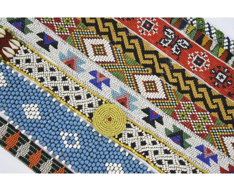 A collection of South African beaded adornments including fifteen necklaces / chokers, one with a bone pendant, six bracelets